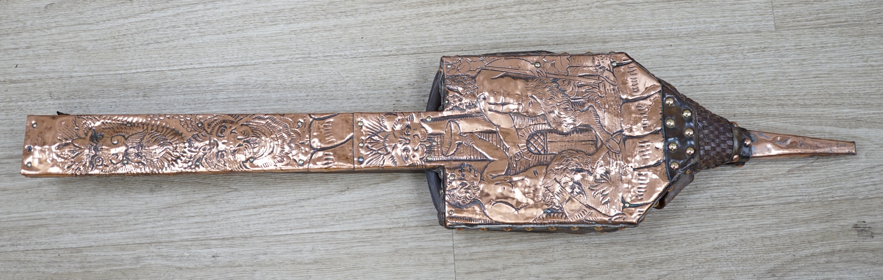 A pair of early 20th century copper bellows embossed with fauns, 81cm in length. Condition - fair